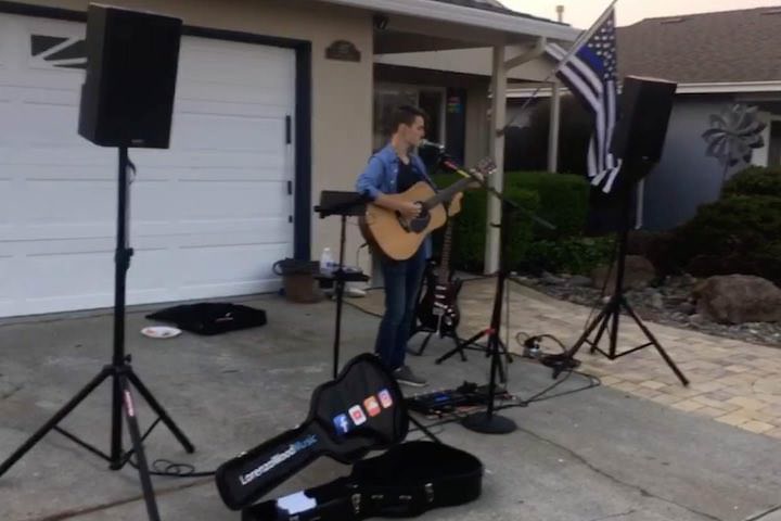 Lorenzo Wood performing at a house concert/block party in 2018